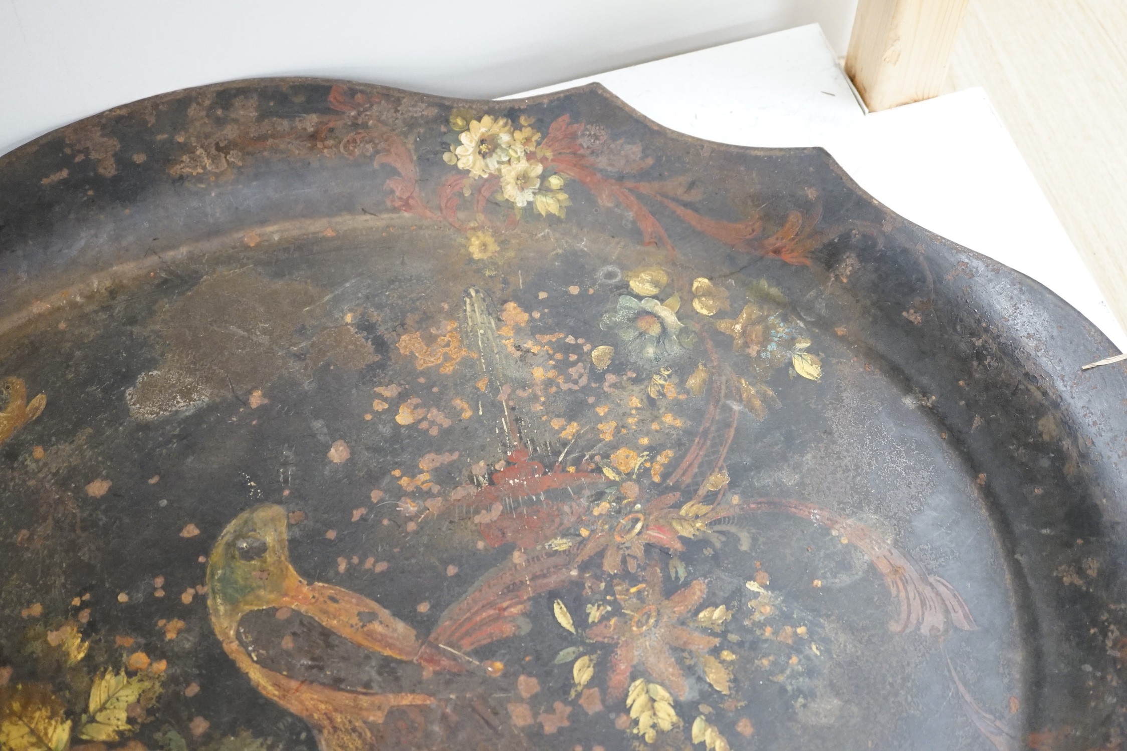 A Victorian painted iron tray with parrot and flower decoration. 82cm wide